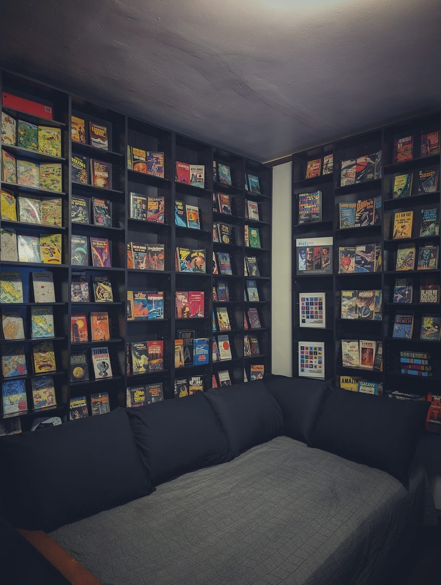 Nate's office — floor-to-ceiling vintage sci-fi paperbacks