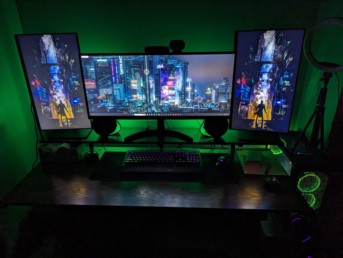 Nate's workstation — triple monitors lit green