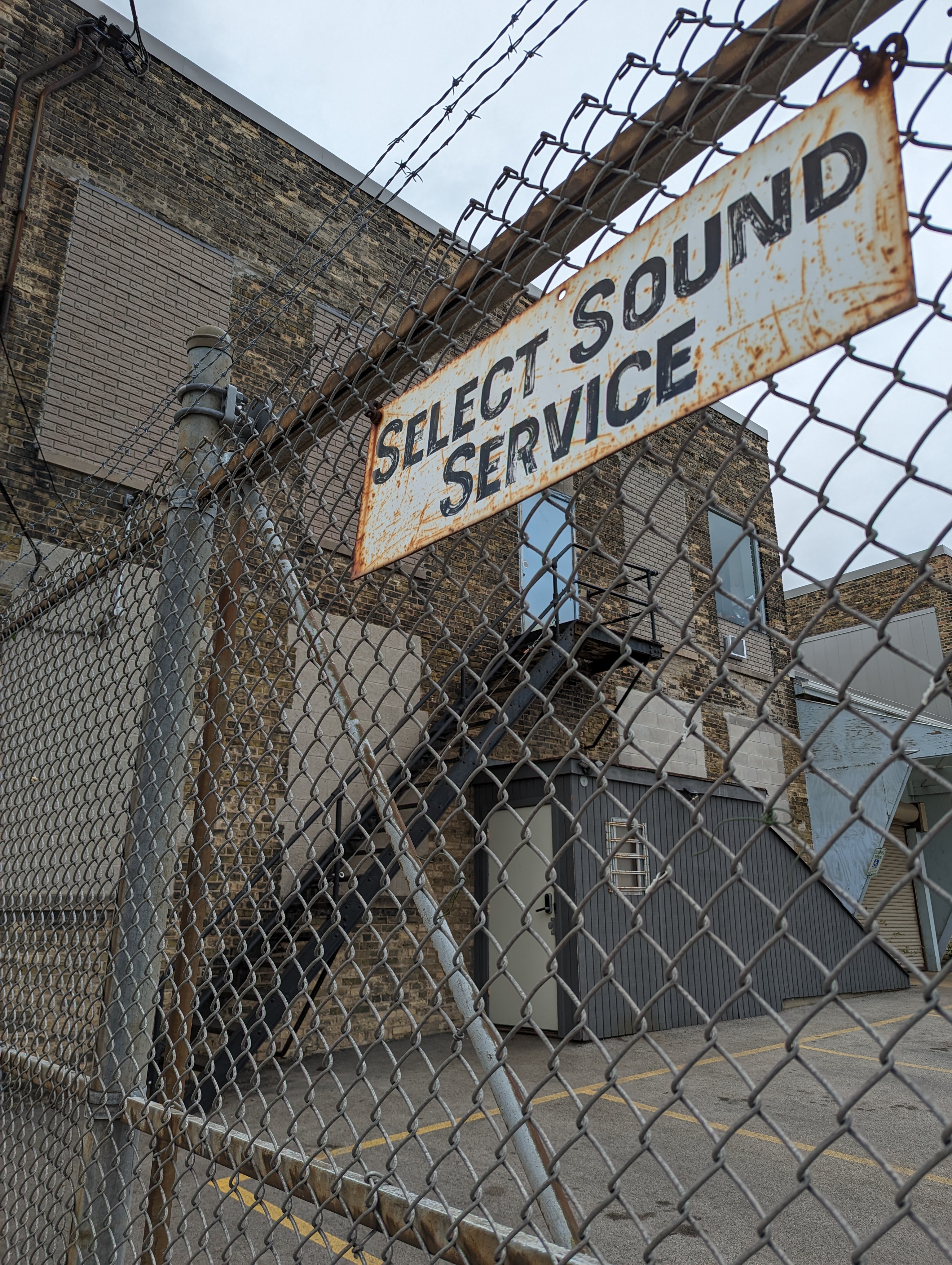 The Select Sound Service sign at the parking-lot gate