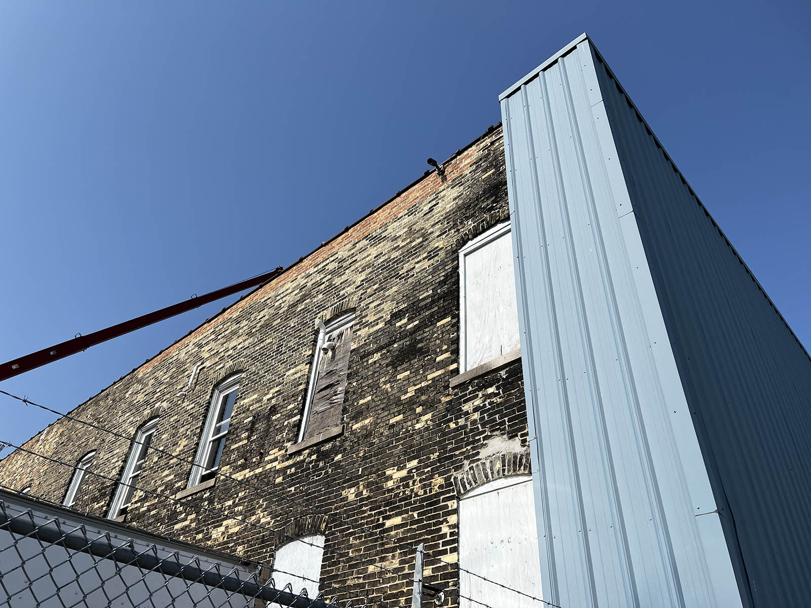 Old Cream City brick meeting newer steel cladding