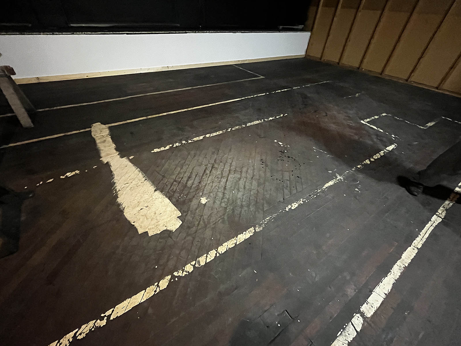 Painted walkway lines on the wooden floor from the printing era